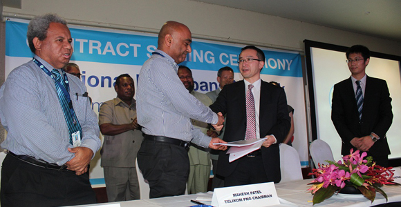 Singing the deal with Huawei. Credit: Telikom PNG