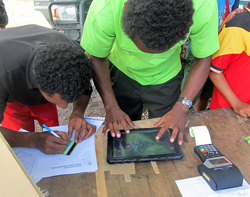BSP Rural staff sign up a farmer at Potuna Village in PNG's Central Province. Credit: BSP