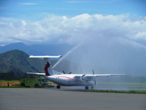 The inaugural Link PNG flight is given the traditional hose down at Lae as it prepares for takeoff.