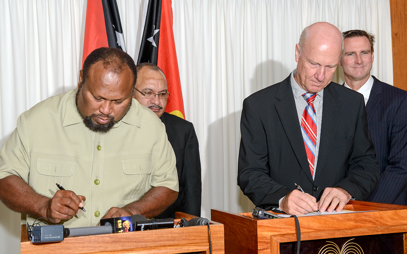 Acting Minister for Petroleum and Energy, the Hon. Ben Micah and ExxonMobil PNG Managing Director, Peter Graham sign the memorandum of understanding, with Papua New Guinea Prime Minister, the Hon. Peter O’Neill, and ExxonMobil PNG Production Manager, Andrew Barry.