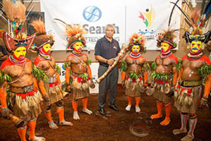 Oil Search Director Gerea Aopi with Relay Baton and Huli Wigman. Credit: Oil Search.