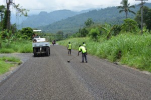 Soft tyre roller and road crew completing the sealing of one of Arawa's town roads.