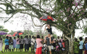 The film crew setting up a shot underneath the largest Bougainvillea tree in Konnou. Credit: World Bank/Alana Holmberg